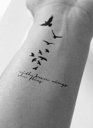 flying small bird tattoo