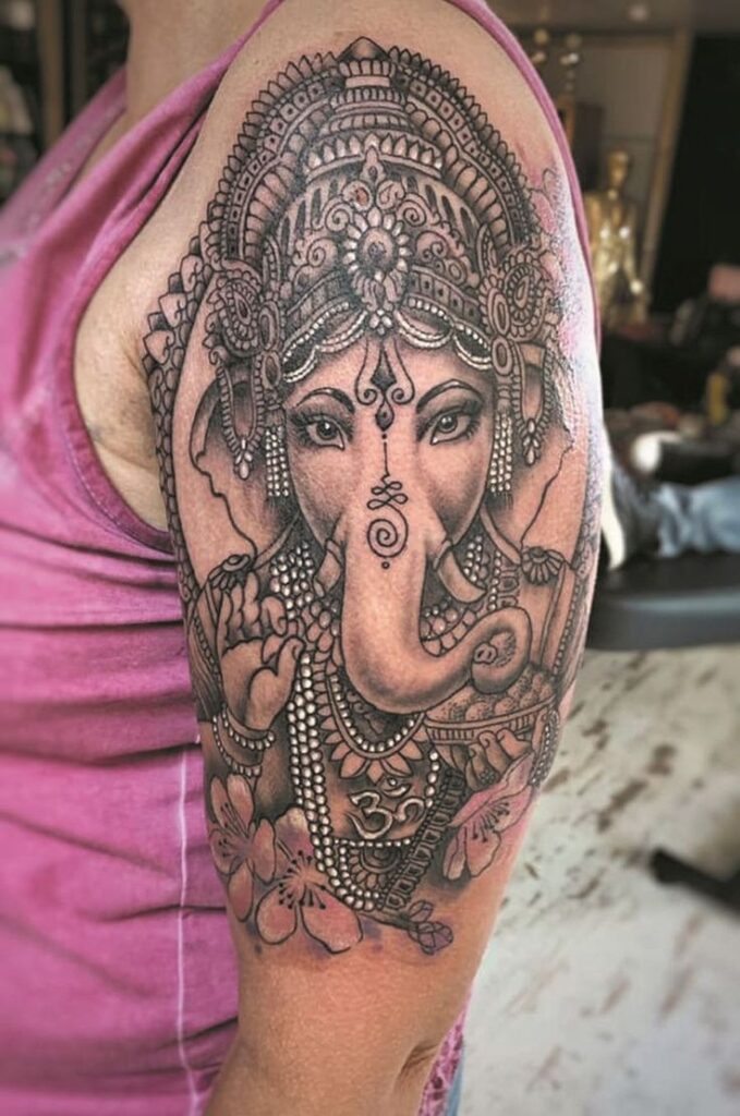 small ganesha tattoo on wrist

