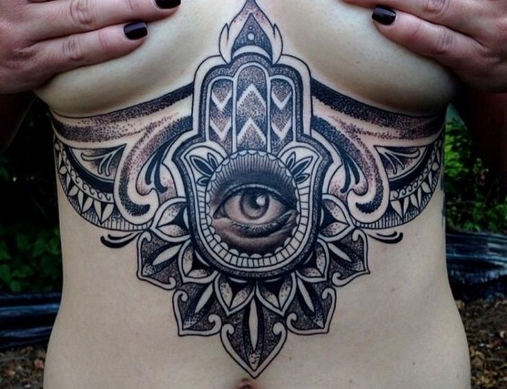 snake tattoo between breast